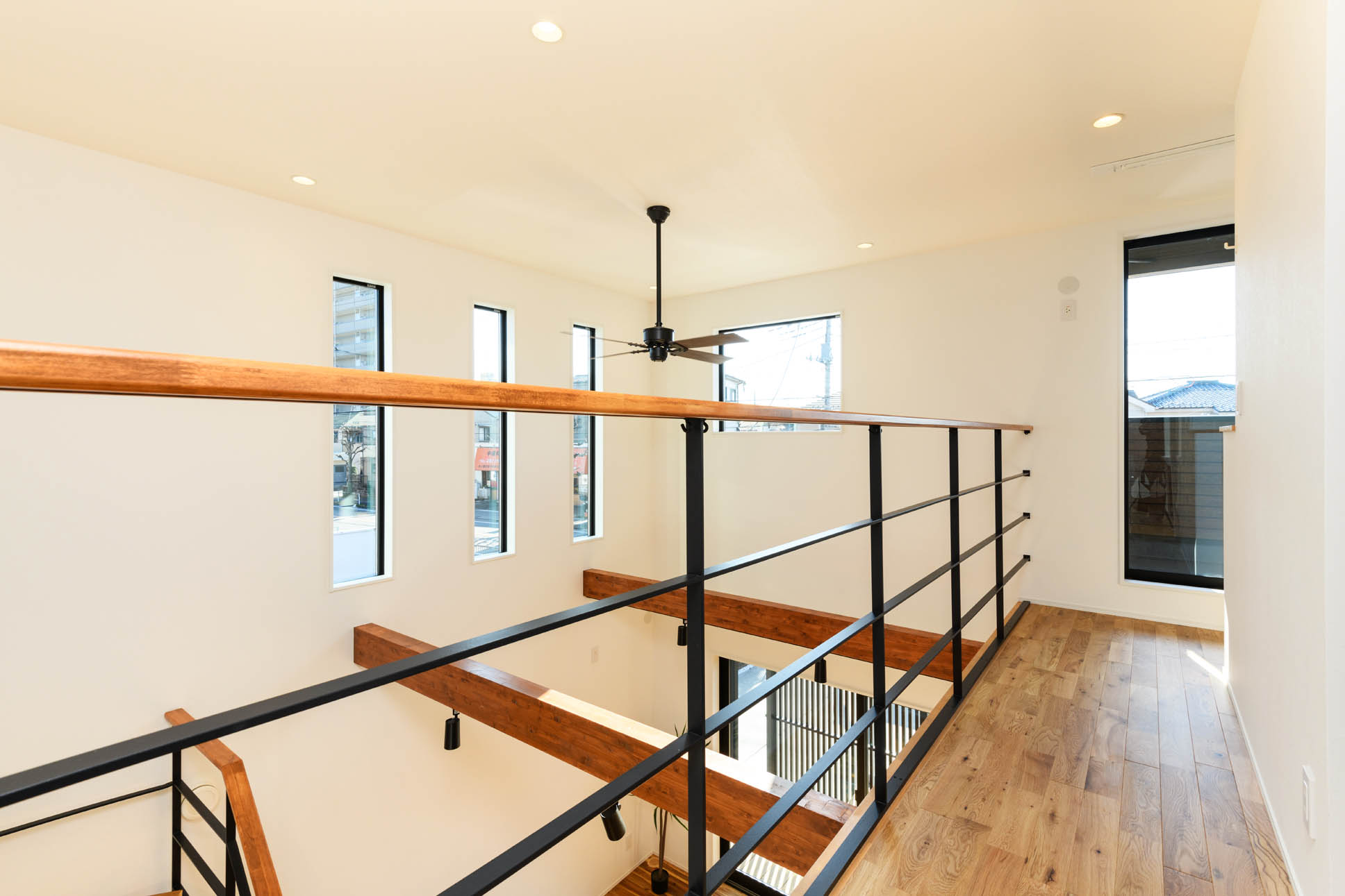 日本語: リビングの吹き抜けを取り囲むように流れる廊下 / English: Corridor surrounding the double-height living space